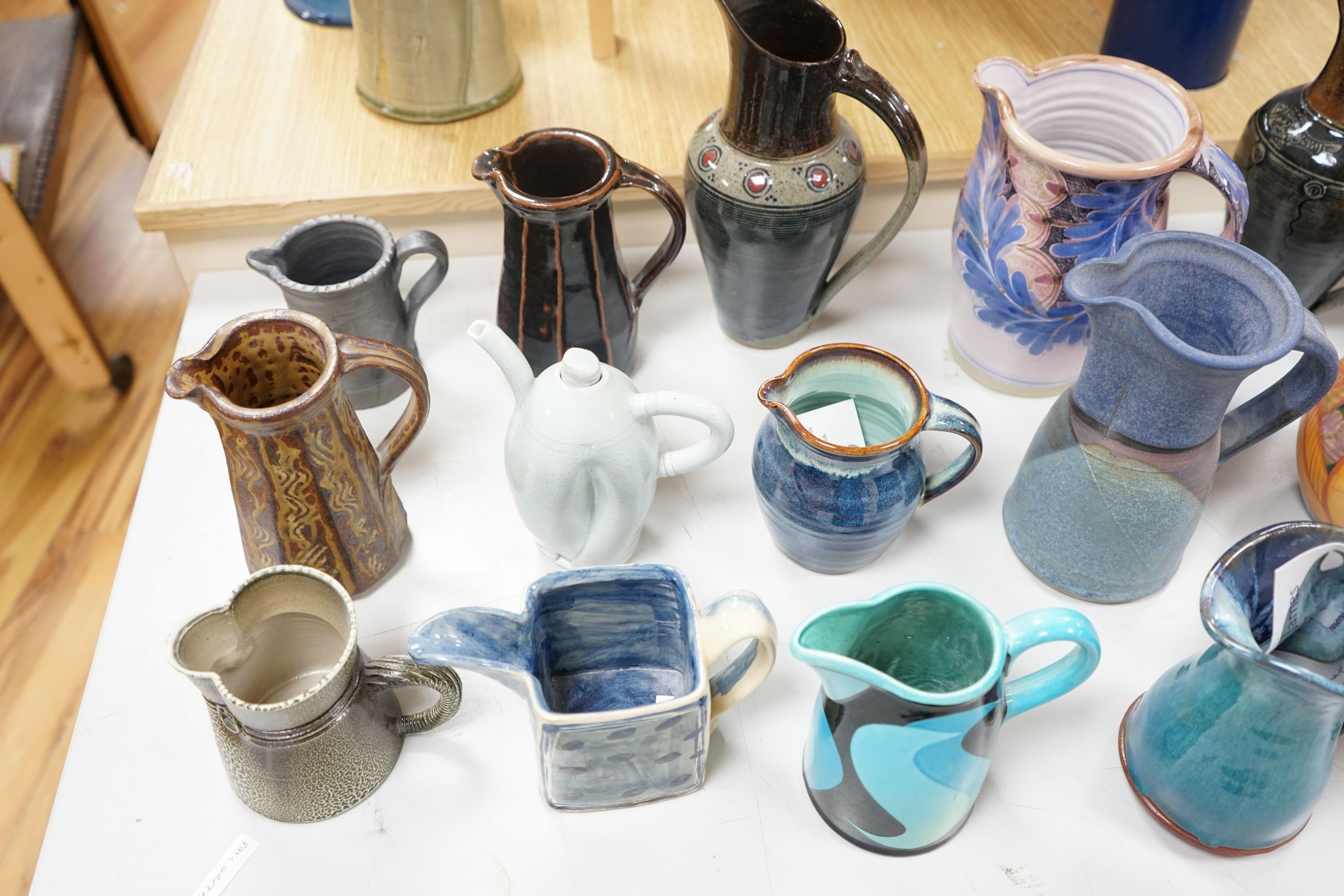 A group of studio pottery jugs to include - 27cm